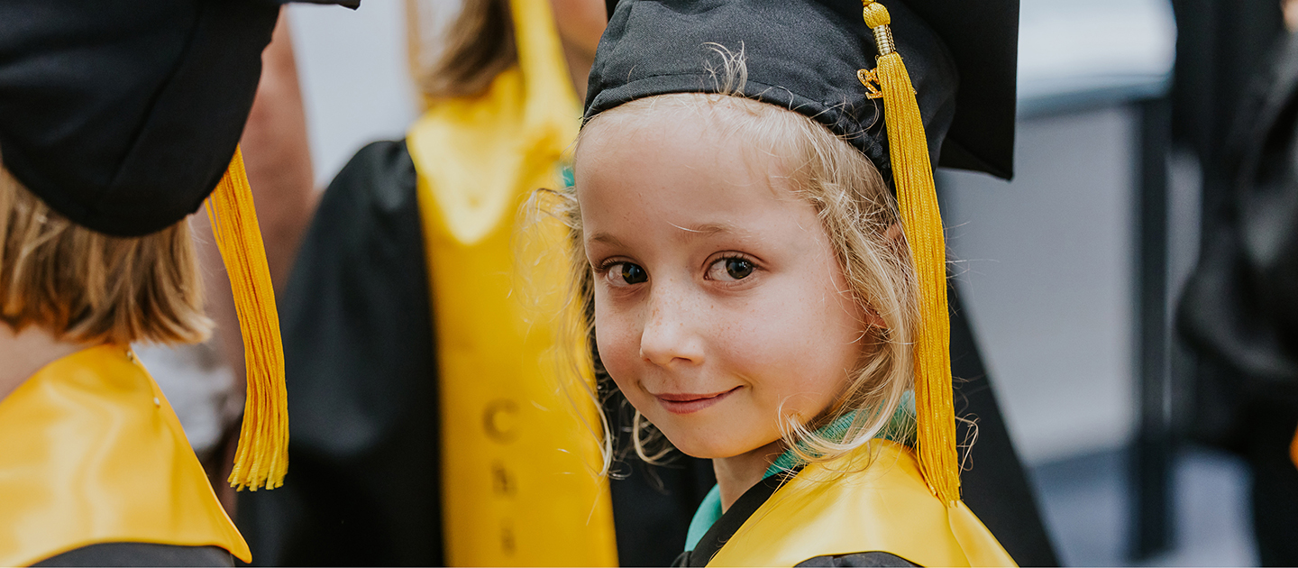 Child dressed in university robes. 