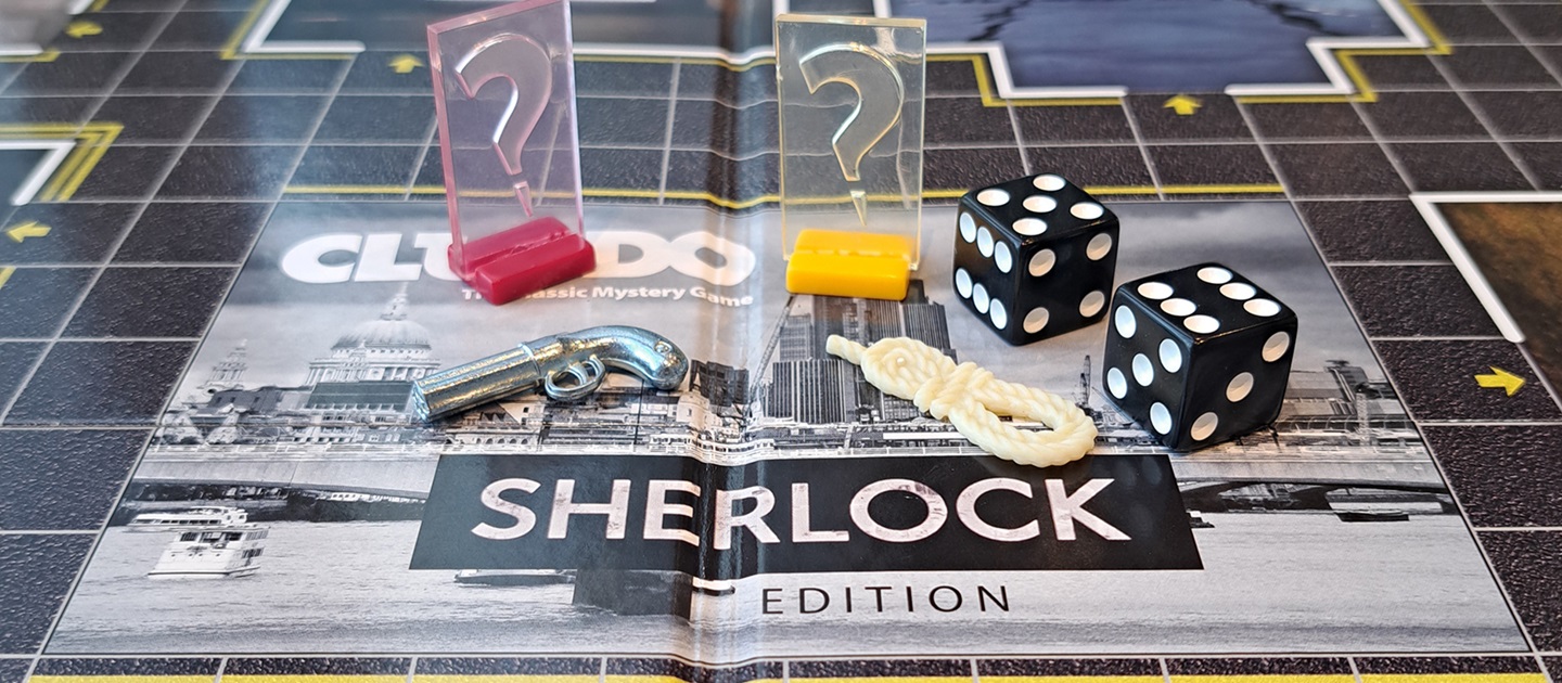 Close up photo of Cluedo - Sherlock edition game board with game pieces and dice.