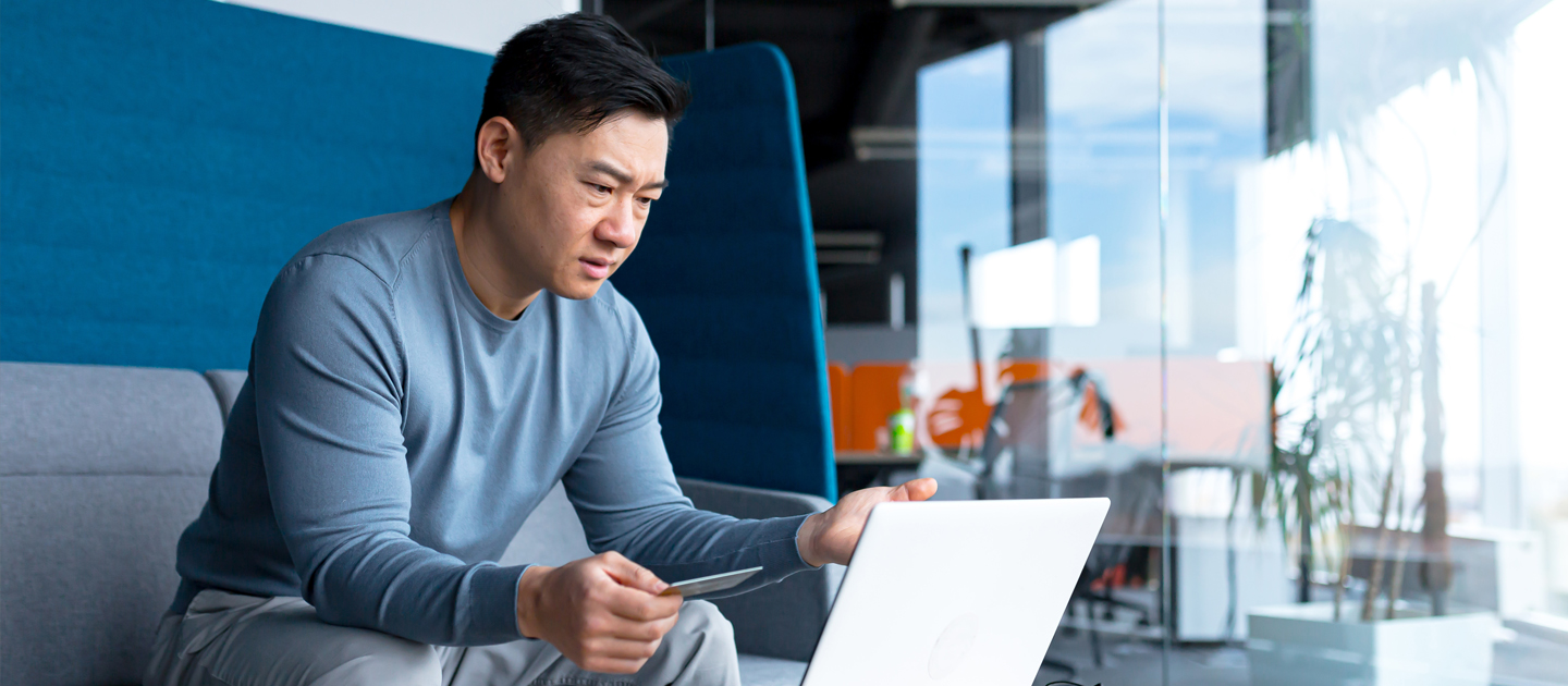 Man with credit card using laptop