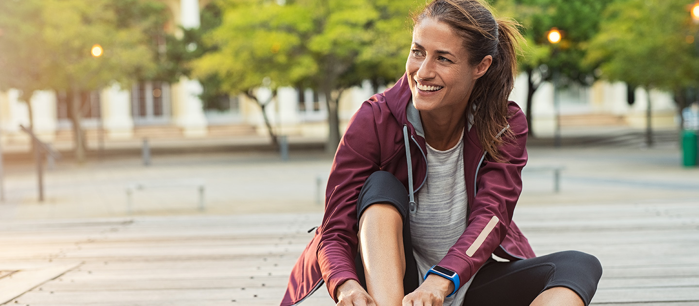 Woman tying up running shoes