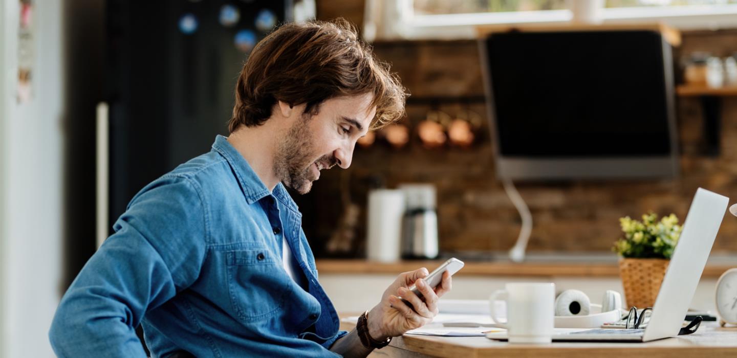Man in wheelchair using smart devices