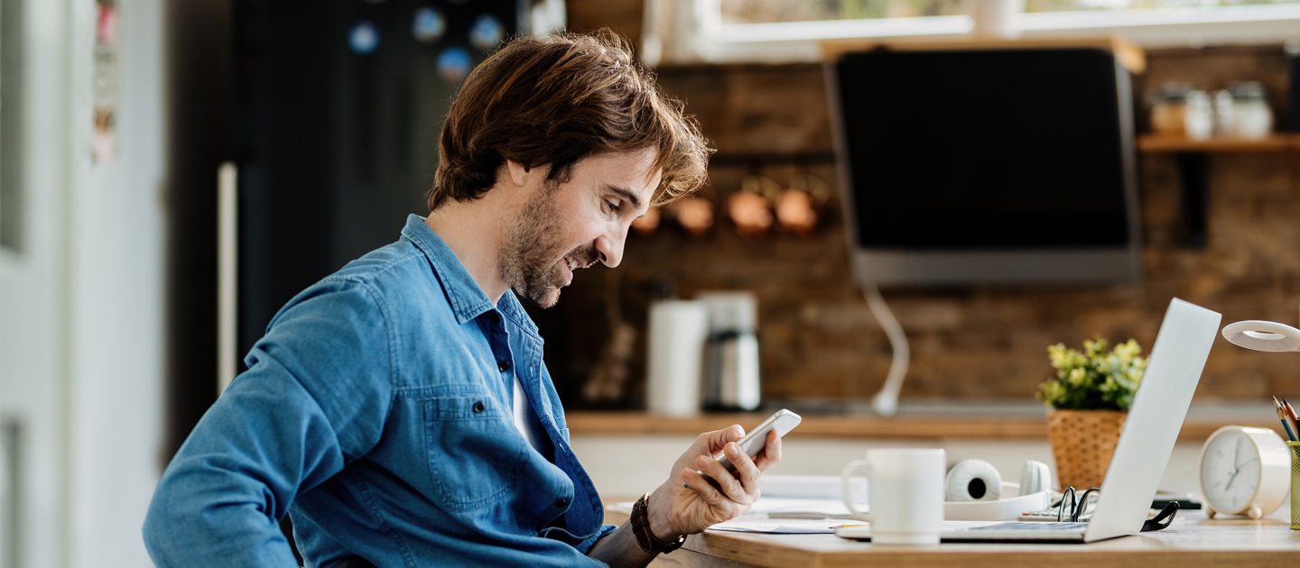 Man in wheelchair using smart devices