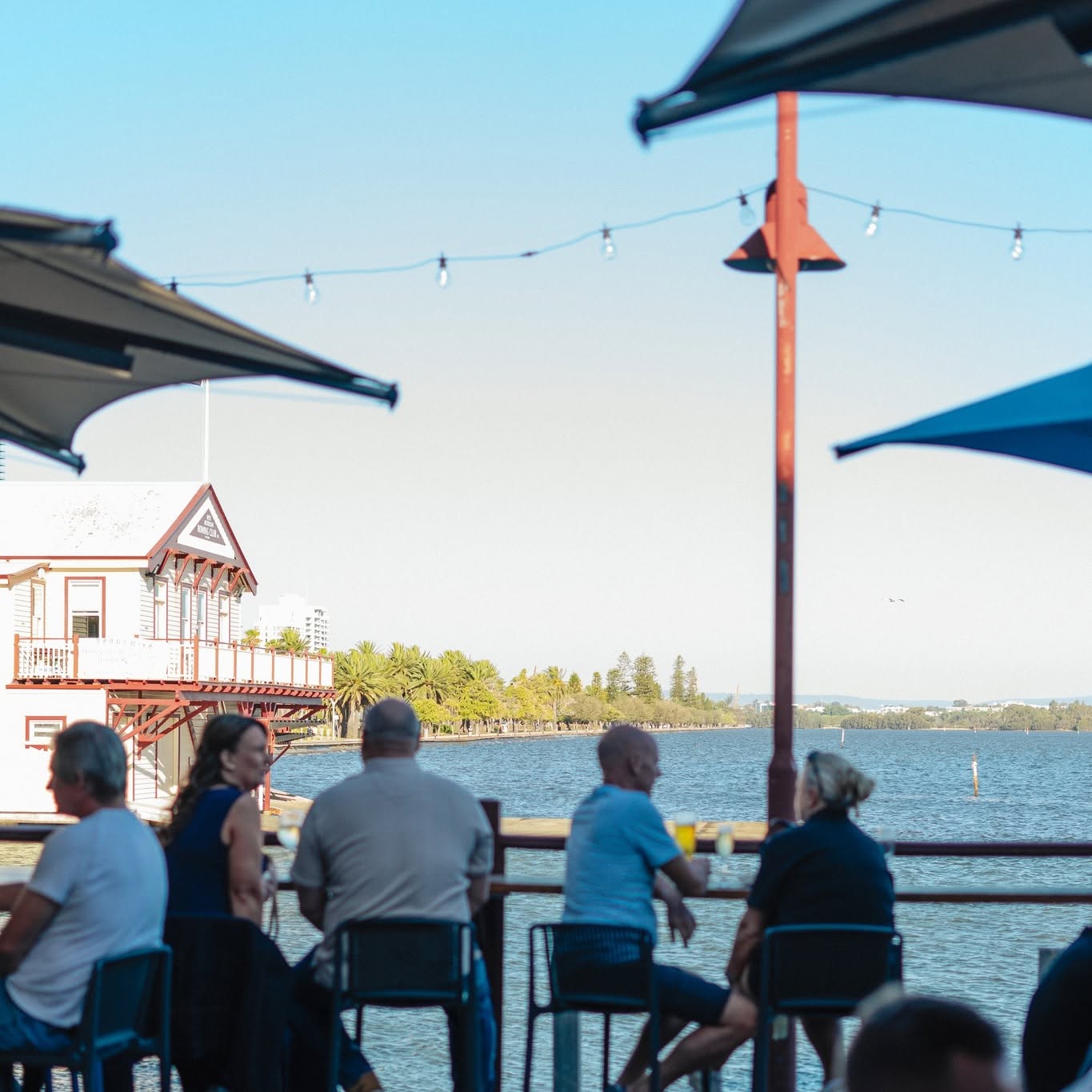 people sitting at waterfront bar