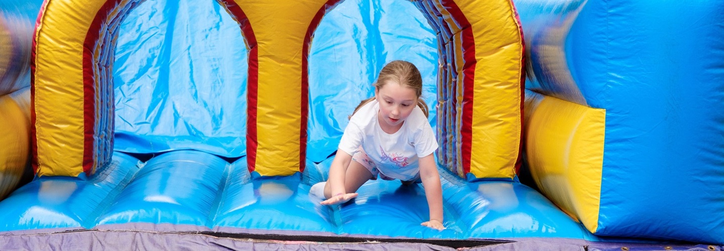 Child playing on a bouncy castle at Telethon Family Fun Day in Forrest Place